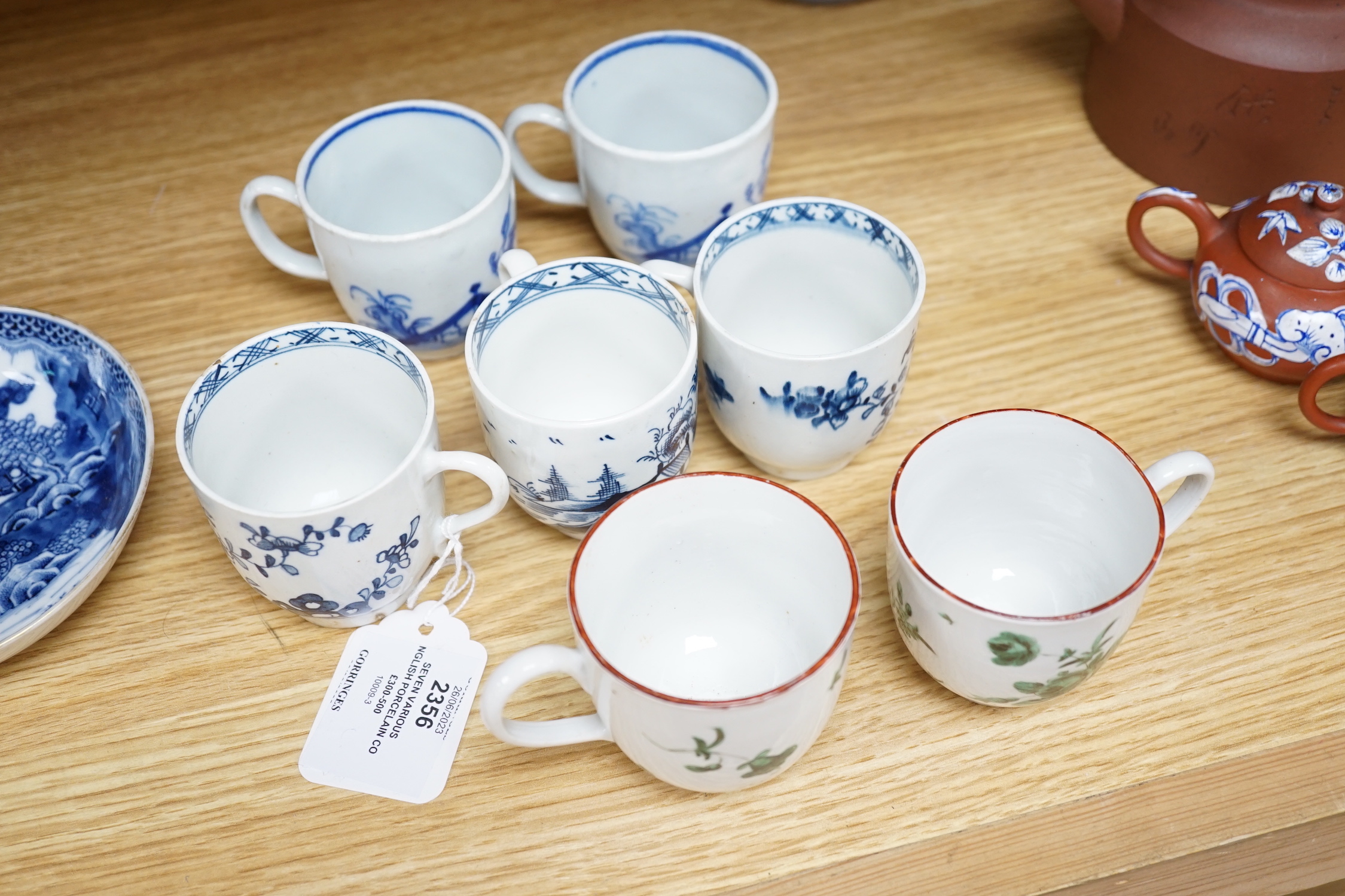 Seven various English porcelain coffee cups, including two Bristol enamelled with green floral sprays, two Bow painted in underglaze blue with a bird in a Chinese garden, and three Worcester/Bow in underglaze blue.